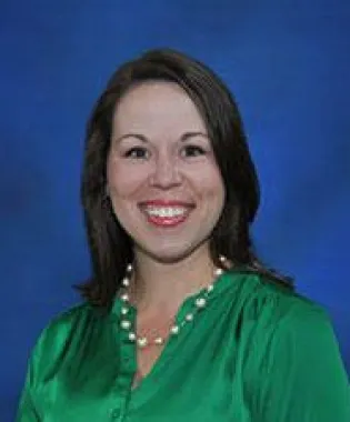 a woman smiling for the camera.