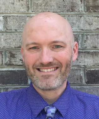 a man smiling at the camera.