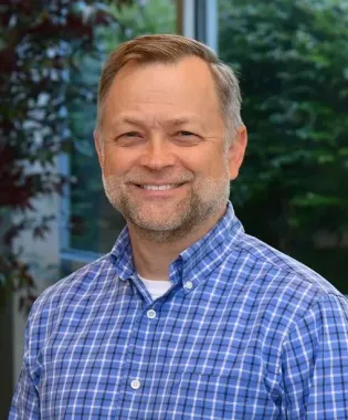 A portrait of Cameron Blevins, MD.