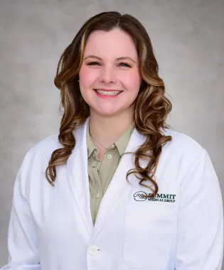 a person smiling for the camera.