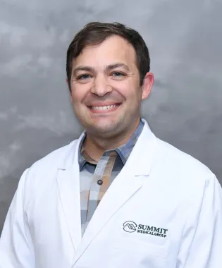 a man wearing a white coat.