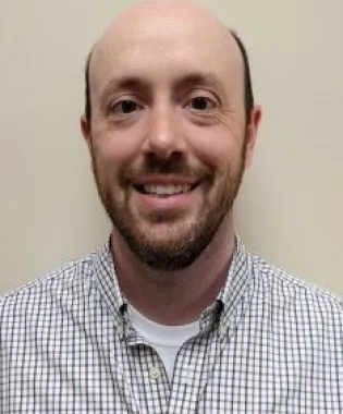 A smiling man with beard.