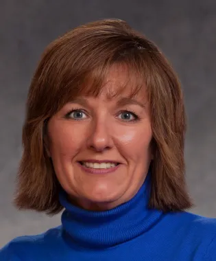 a person who is smiling and looking at the camera.
