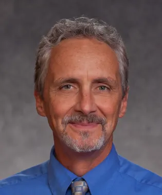 Man wearing a tie and blue shirt.