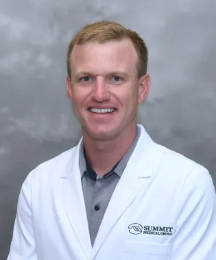a man wearing a white coat.