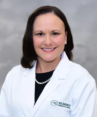 a woman in a white coat.