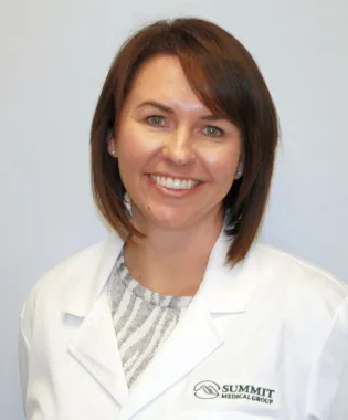 a woman smiling for the camera.
