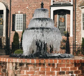 a statue in front of a brick building