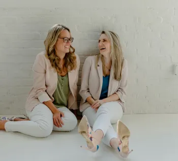 a couple of women sitting on the floor