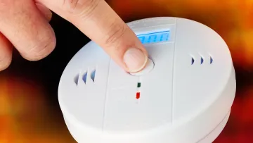a hand holding a white device