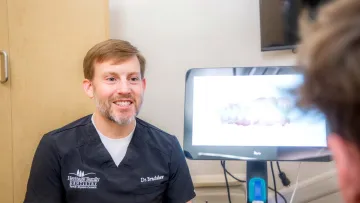 a man smiling at the camera
