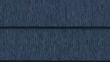 Close-up of dark blue textured horizontal wooden siding panels on a building exterior.