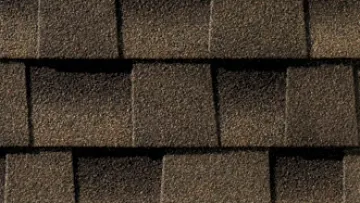 Modern house with asphalt shingle roof and detailed close-up of brown roofing shingles texture.