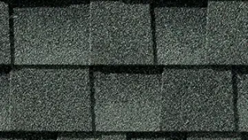 Modern house with new gray architectural shingles roof and close-up of shingle texture detail.
