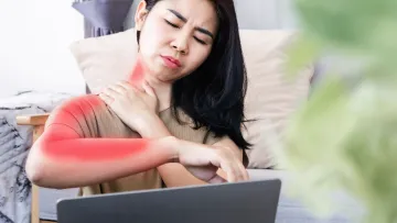 a woman with her eyes closed holding her neck