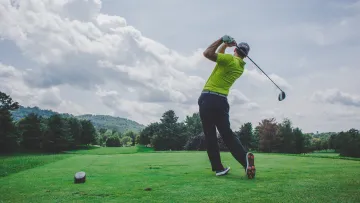a man swinging a golf club
