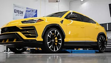 Yellow Lamborghini Urus luxury SUV parked indoors highlighting sleek design and black accents
