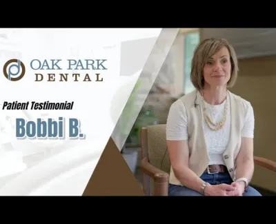Woman giving a patient testimonial for Oak Park Dental seated in a chair in a bright office setting