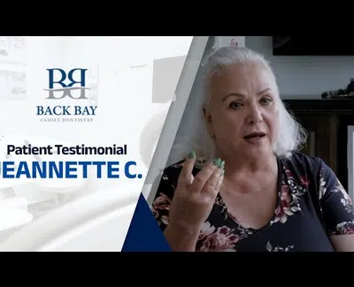Patient testimonial from Jeannette C. for Back Bay Family Dentistry, featuring a smiling elderly woman.