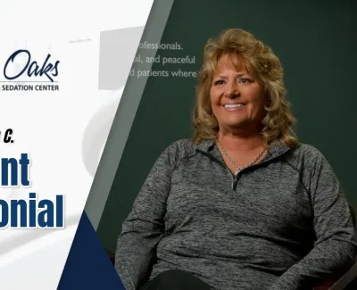 Smiling woman Kathleen C. giving a patient testimonial for The Implant Center at North Oaks Dental