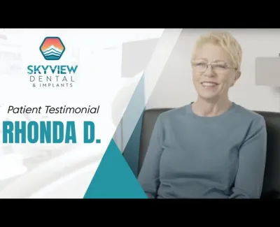 Smiling woman giving a testimonial for Skyview Dental and Implants with logo and text on screen.