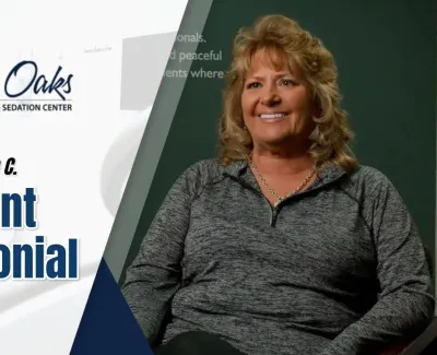 Smiling woman shares a patient testimonial for The Implant Center at North Oaks Dental
