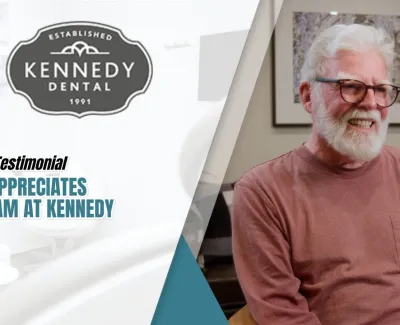 Elderly man smiling during a patient testimonial for Kennedy Dental with logo and text overlay.