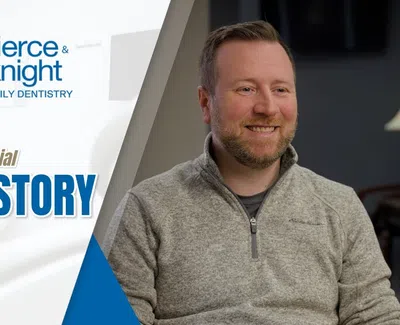 Smiling man shares his testimonial for Pierce & Knight Family Dentistry in a professional setting.
