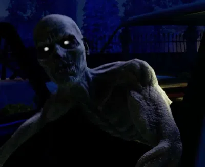 Dark, eerie scene of two glowing-eyed zombies approaching a car at night in a spooky setting.