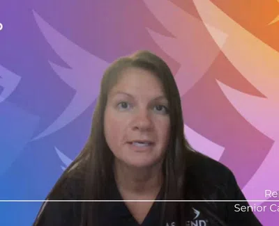 Senior care provider Rebecca speaking in front of a colorful Ascend Medical branded background