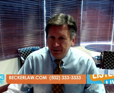 Professional man in office setting with tie speaking in video call overlayed with Beckerlaw.com contact info.