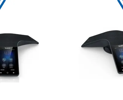 Two black Yealink conference phones with touchscreens displayed on a white surface with blue corner accents.