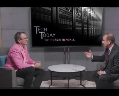 Two men discuss technology on the Tech Today with David Rendall show in a modern studio setting.
