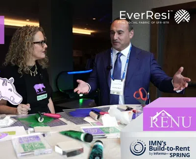 Two professionals discuss community building at EverResi activation event with LocalHippo and RENU branding visible.