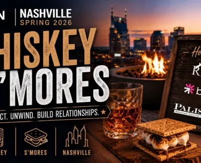Whiskey glass and toasted s'mores by fire pit with Nashville skyline at sunset for Whiskey & S'mores event.