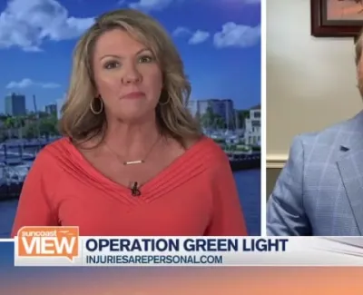 TV news segment on Operation Green Light featuring a female host and male guest in a split screen format.