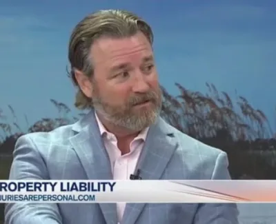 Man in light blue blazer speaking on Suncoast View about property liability and personal injury law.