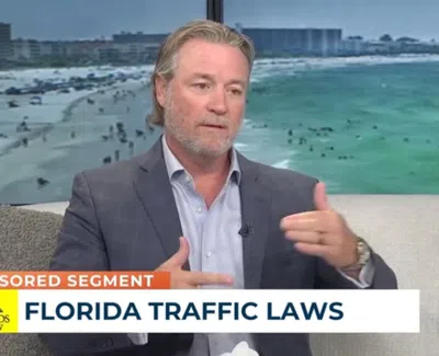 Man in suit discussing Florida traffic laws with overlaid text reading Florida Traffic Laws and sponsored segment logo.