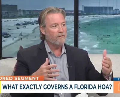 Man in suit jacket discussing Florida HOA governance on a TV segment with beach backdrop and overlaid text