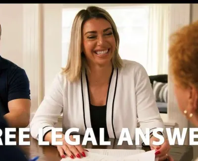 Smiling female lawyer providing free legal answers to clients in a professional office setting.