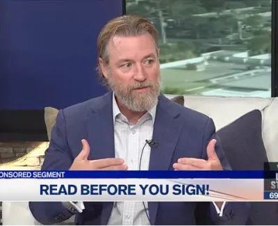 Man in blue suit explaining contract details during a legal advice segment on local TV show.