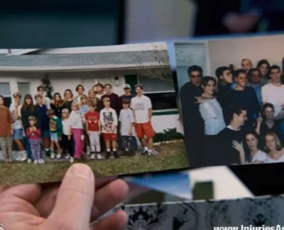 Hands holding two printed group photos featuring diverse people in casual and indoor settings.