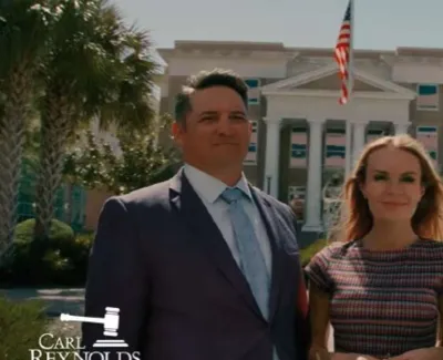 Three professionals standing confidently in front of a courthouse with an American flag and palm trees.