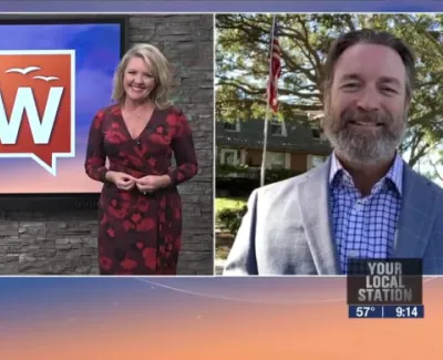 TV news segment with female host and male guest outdoors, Suncoast View logo, and local station info