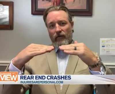 Man in beige suit explaining rear end crashes during a news segment on ABC 7 with informational text overlay.
