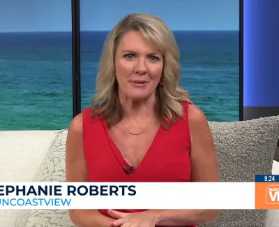 TV host Stephanie Roberts presenting Suncoast View with ocean backdrop and temperature display.