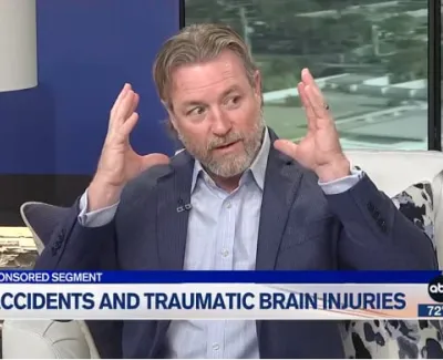 Male expert explains brain injury during televised segment on accidents and traumatic brain injuries.