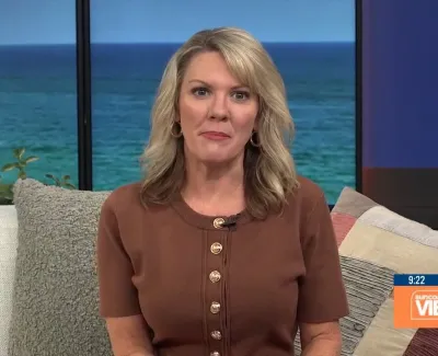 Blonde woman in brown buttoned shirt sitting on a couch with ocean view background and Suncoast View logo.