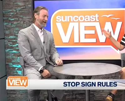 Two hosts discussing stop sign rules on Suncoast View TV show with show logo in the background.