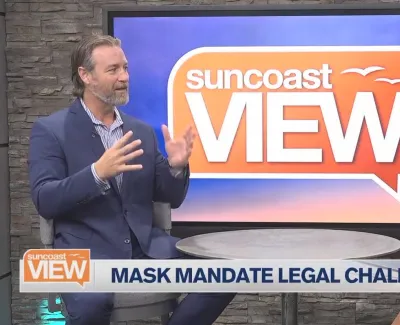 Two hosts discussing mask mandate legal challenges on Suncoast View TV show set